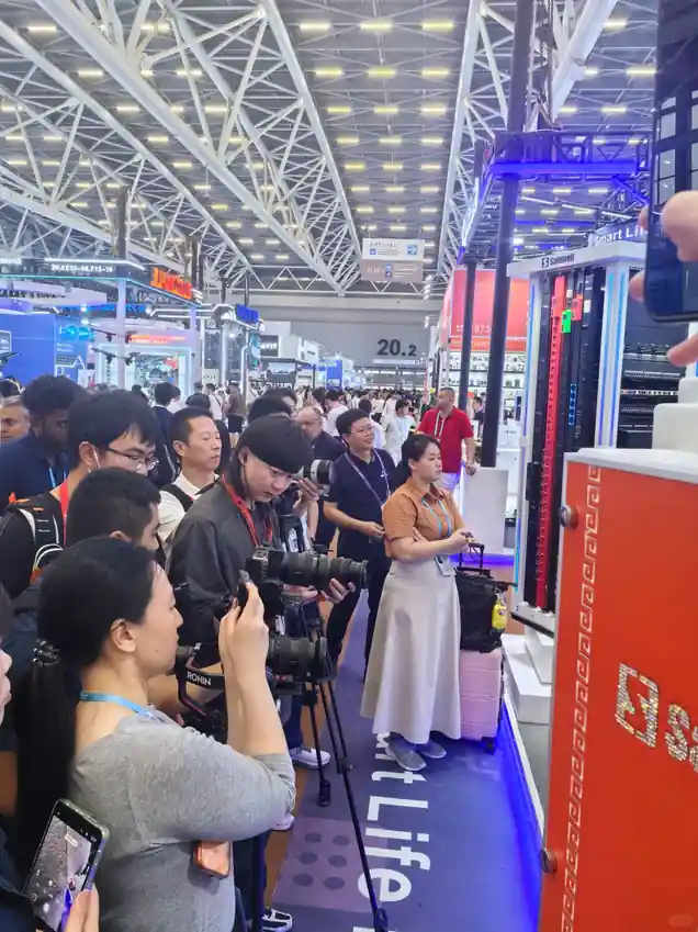 Buyers documenting a live product demonstration at a Canton Fair booth