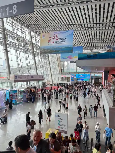 Overseas buyers moving through a busy corridor inside the Canton Fair Complex
